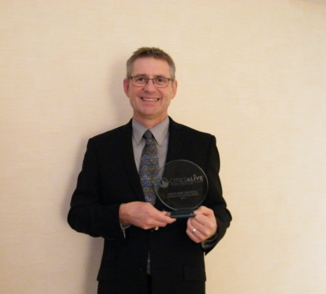 Senior partner George Berry holds the International Green Roof Award in New York City, NY.