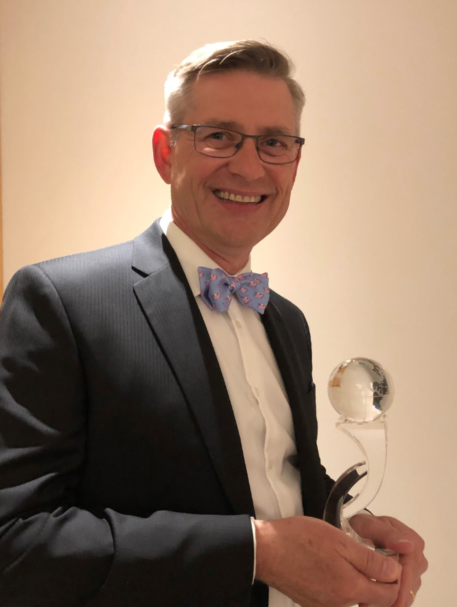 Senior partner George Berry beams while holding the award for “Most Outstanding Seniors’ Housing Architect of 2018” in London, UK.